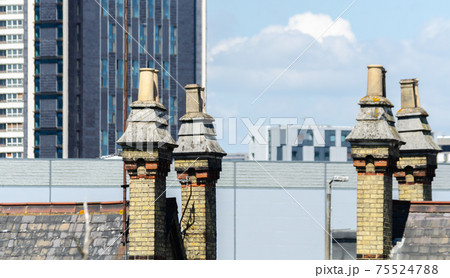 Typical English chimneys on the roofs of London buildings Typical English chimneys on the roofs of London buildings 75524788