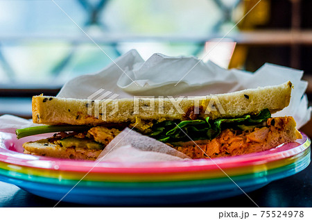 chicken breast in tikka spices, served with onion bhaji, crisp spinach and crunchy cucumber, all in sandwich 75524978