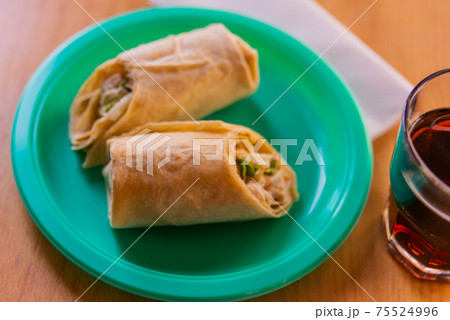 Chicken breast with caesar dressing and lettuce in a gluten-free tortilla wrap Chicken breast with caesar dressing and lettuce in a gluten-free tortilla wrap 75524996