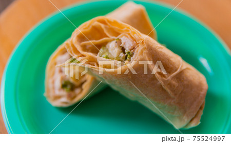 Chicken breast with caesar dressing and lettuce in a gluten-free tortilla wrap Chicken breast with caesar dressing and lettuce in a gluten-free tortilla wrap 75524997