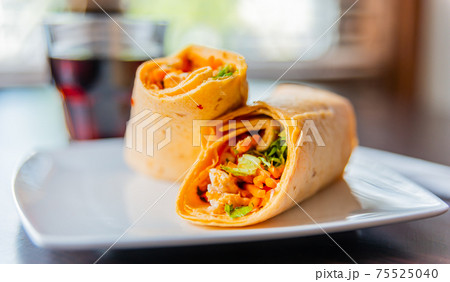 Chicken breast with piri piri sauce and lettuce in a chili tortilla wrap Chicken breast with piri piri sauce and lettuce in a chili tortilla wrap 75525040