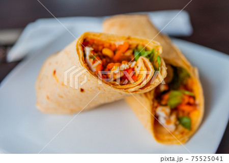 Chicken breast with piri piri sauce and lettuce in a chili tortilla wrap Chicken breast with piri piri sauce and lettuce in a chili tortilla wrap 75525041