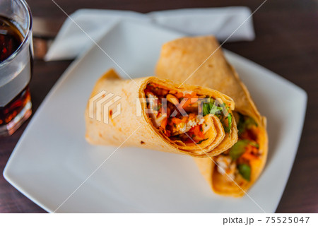 Chicken breast with piri piri sauce and lettuce in a chili tortilla wrap 75525047
