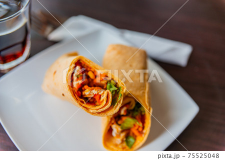 Chicken breast with piri piri sauce and lettuce in a chili tortilla wrap Chicken breast with piri piri sauce and lettuce in a chili tortilla wrap 75525048