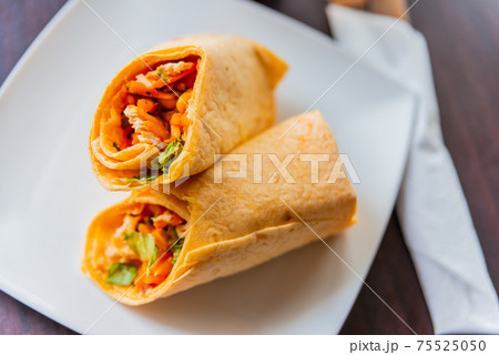 Chicken breast with piri piri sauce and lettuce in a chili tortilla wrap Chicken breast with piri piri sauce and lettuce in a chili tortilla wrap 75525050