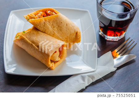Chicken breast with piri piri sauce and lettuce in a chili tortilla wrap Chicken breast with piri piri sauce and lettuce in a chili tortilla wrap 75525051
