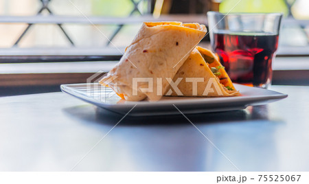 Chicken breast with piri piri sauce and lettuce in a chili tortilla wrap Chicken breast with piri piri sauce and lettuce in a chili tortilla wrap 75525067