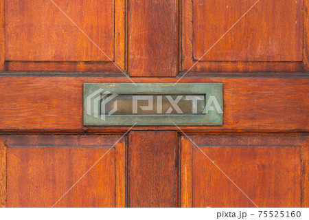 Old letterbox in the door, traditional way of delivering letters to the house, old mailbox Old letterbox in the door, traditional way of delivering letters to the house, old mailbox 75525160