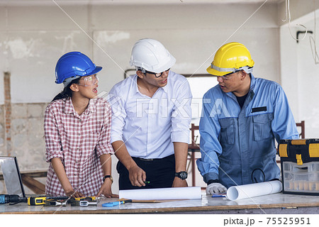 Construction engineer teamwork Safety Suit Trust Team Holding White Yellow Safety hard hat Security Equipment on Construction Site. Hardhat Protect Head for Civil Construction Engineer Concept Construction engineer teamwork Safety Suit Trust Team Holding White Yellow Safety hard hat Security Equipment on Construction Site. Hardhat Protect Head for Civil Construction Engineer Concept 75525951
