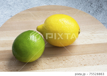Juicy ripe citrus on an old wooden table - lime, lemon 75528863