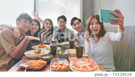 friends take selfie in restaurant 75529519