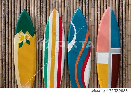 colorful surfboards on bamboo wooden wall 75529883