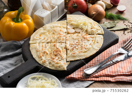 Flatbread with sausage and mozzarella cheese filling Flatbread with sausage and mozzarella cheese filling 75530262