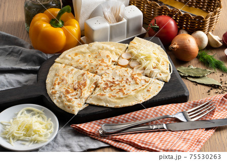 Flatbread with sausage and mozzarella cheese filling 75530263