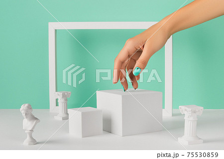 Womans hand podium and frame over turquoise background Womans hand podium and frame over turquoise background 75530859