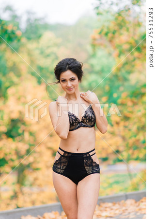 Beautiful young woman in lingerie in autumn forest Beautiful young woman in lingerie in autumn forest 75531293