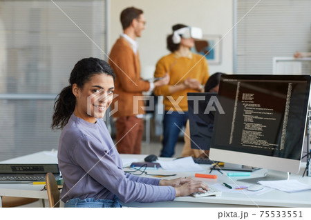 Ethnic Young Woman Programming Software in Office 75533551