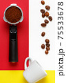 Espresso machine filter with ground coffee, coffee beans and  white cup. 75533678