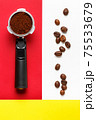 Espresso machine filter with ground coffee and coffee beans. 75533679