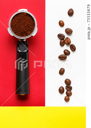 Espresso machine filter with ground coffee and coffee beans. Espresso machine filter with ground coffee and coffee beans. 75533679