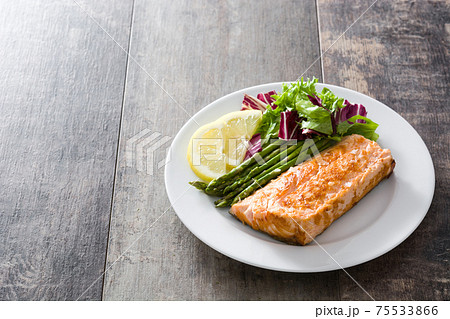 Grilled salmon fillet with asparagus and salad Grilled salmon fillet with asparagus and salad 75533866