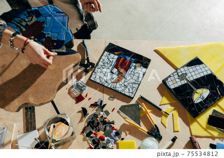 Designer working of new mosaics while spending time at her modern studio Designer working of new mosaics while spending time at her modern studio 75534812