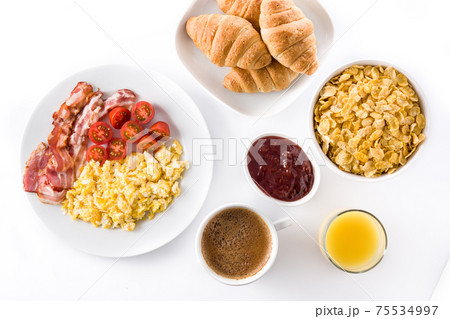 Breakfast with scrambled eggs, bacon, tomatoes,coffee,orange juice ,croissant and corn flakes isolated on white background Breakfast with scrambled eggs, bacon, tomatoes,coffee,orange juice ,croissant and corn flakes isolated on white background 75534997