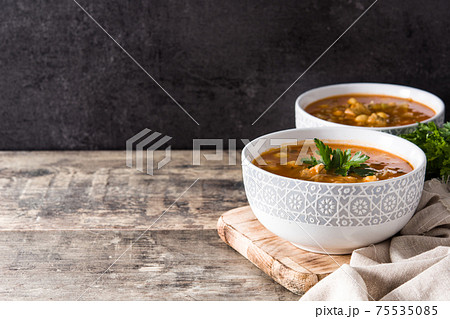 Harira soup in bowl on wooden table. Typical Moroccan food. Ramadan concept. 75535085