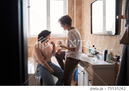 Lesbian female showing their smiles while spending time at the bathroom 75535262