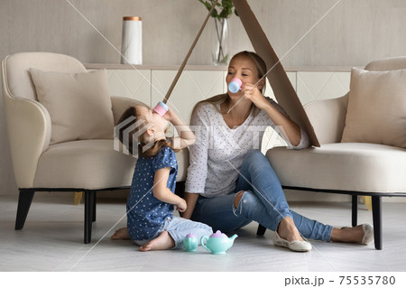 Caring mom and little daughter play at home 75535780