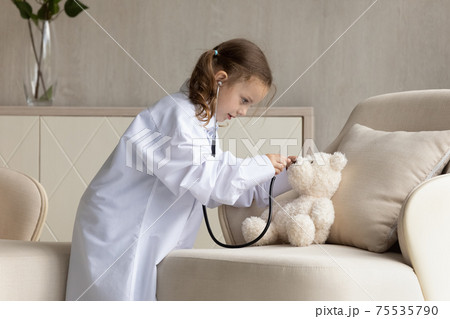 Little girl child play doctor with toy at home Little girl child play doctor with toy at home 75535790