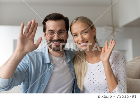 Screen view of happy couple greet talking on webcam Screen view of happy couple greet talking on webcam 75535791