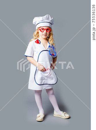 Little girl in costume of doctor profession isolated on grey 75536136