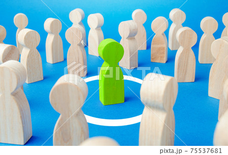 Figurine of green man stands in a white circle among a large crowd of people. Personal space, comfort zone. Protection and privacy concept. Immunity security. Keep distance. Isolate from society Figurine of green man stands in a white circle among a large crowd of people. Personal space, comfort zone. Protection and privacy concept. Immunity security. Keep distance. Isolate from society 75537681