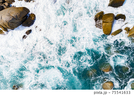 Amazing aerial view of crashing waves on rocks seascape nature view and Beautiful tropical sea with Sea coast view in summer season image by Drone High angle view Travel and website background concept 75541633
