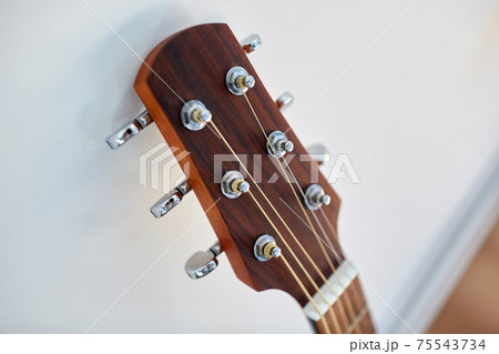 close up of acoustic guitar head with pegs close up of acoustic guitar head with pegs 75543734