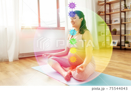happy pregnant woman meditating with seven chakras happy pregnant woman meditating with seven chakras 75544043