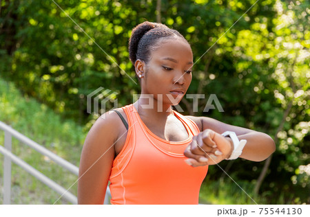 african woman with smart watch doing sports african woman with smart watch doing sports 75544130