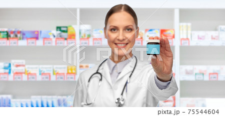 smiling female doctor with medicine at pharmacy smiling female doctor with medicine at pharmacy 75544604