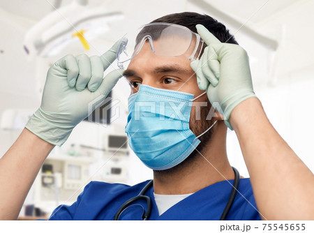 male doctor in goggles, mask and gloves male doctor in goggles, mask and gloves 75545655