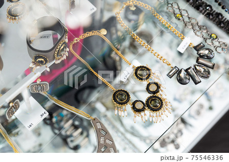 Stylish ornaments for sale on glass shelves of bijouterie boutique 75546336