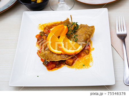 Black sole fish with stewed vegetables and orange Black sole fish with stewed vegetables and orange 75546376