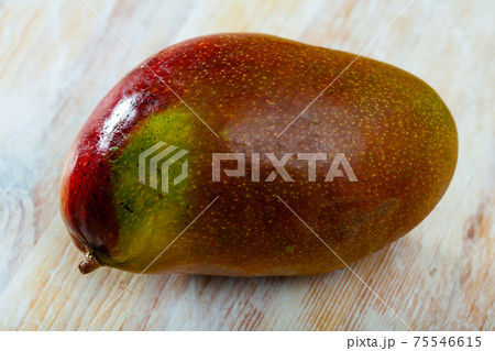 Ripe mango on wooden table Ripe mango on wooden table 75546615
