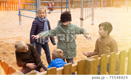 Happy children playing blind man bluff 75546924