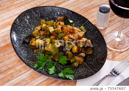 Healthy vegetarian dinner, braised vegetables on plate 75547607