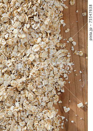 Cereals and healthy eating concept — oatmeal flakes. Natural background 75547638