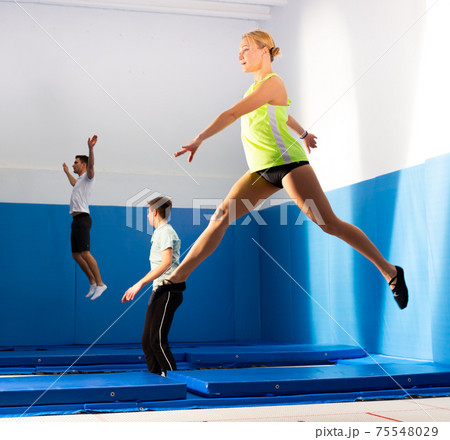 Athletic girl training in trampoline center Athletic girl training in trampoline center 75548029