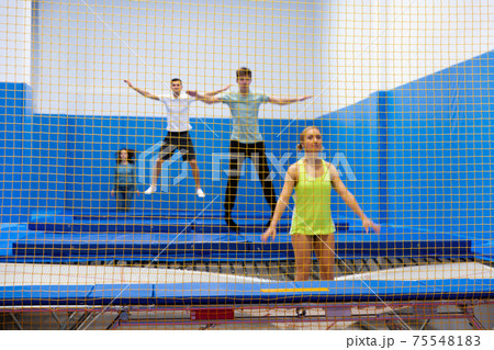 Positive people during training in trampoline center Positive people during training in trampoline center 75548183