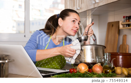 Woman looking for recipe on Internet 75549314