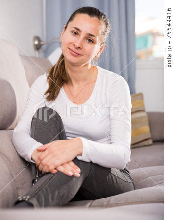 Woman lying and posing on couch Woman lying and posing on couch 75549416